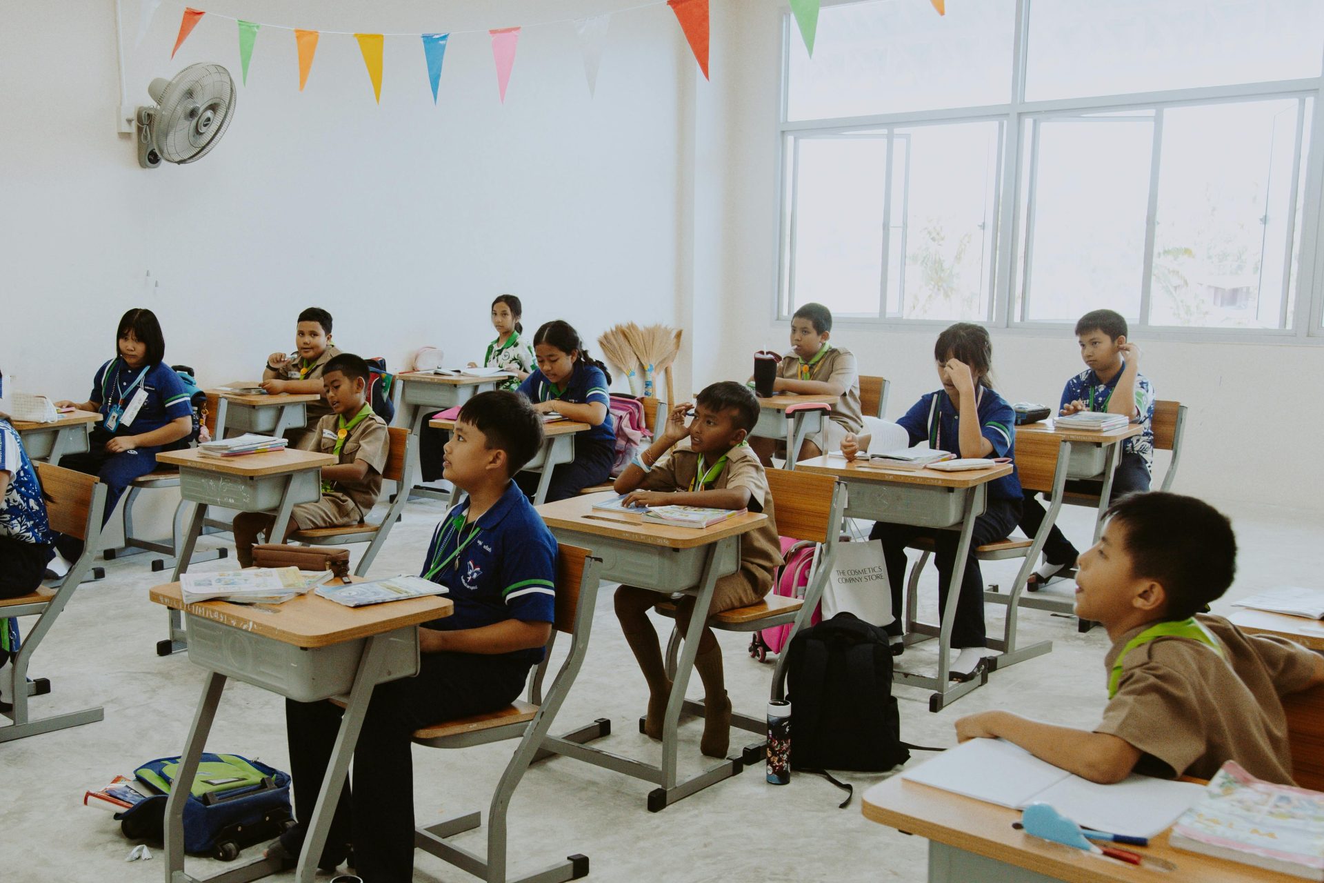 Students attentively participating in a diverse classroom lesson.